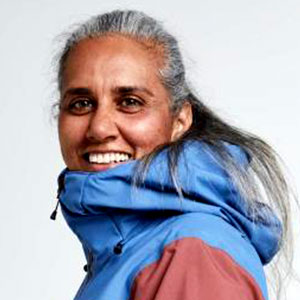 Humaira Falkenberg is a medium-dark skinned female with long grey hair. She smiles warmly and wears a blue and plum colored windbreaker.