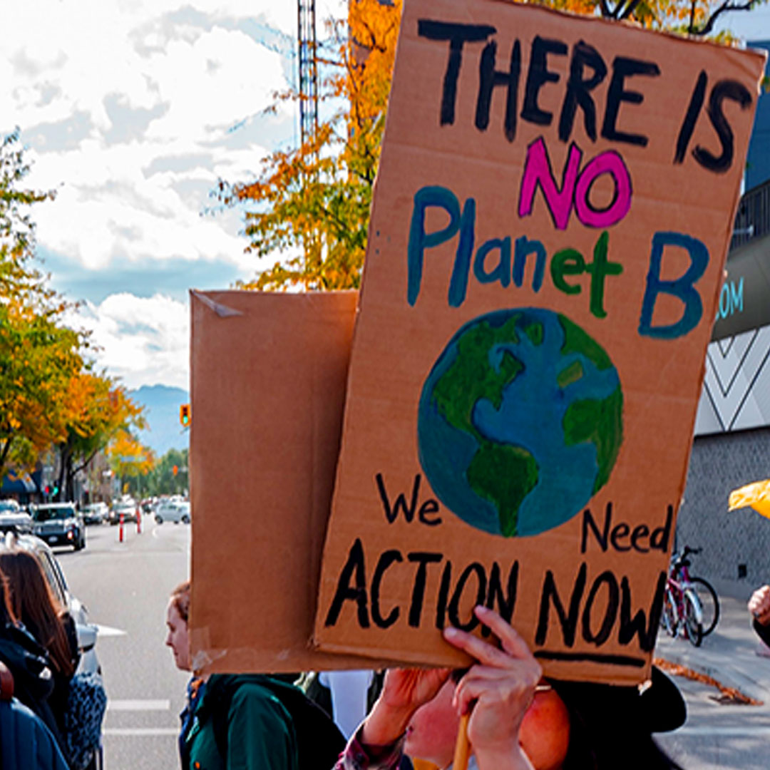Climate marcher holding sign that says There Is No Planet B