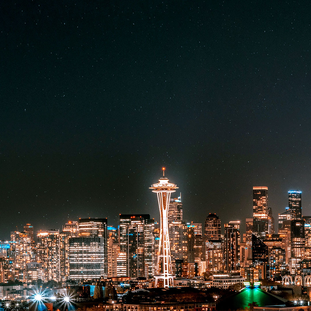 Night view of the glittering Seattle skyline with a brightly lit Space Needle front and center