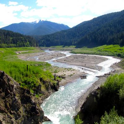 River winding through valley with mountain in the background