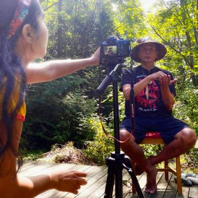 Native American Story Teller Being Filmed in a Wooded Setting