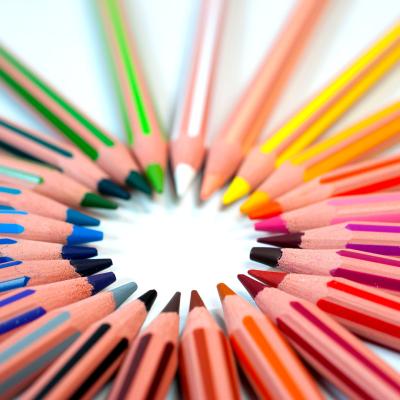 Brightly colored pencils with tips arranged in a circle to represent inclusion