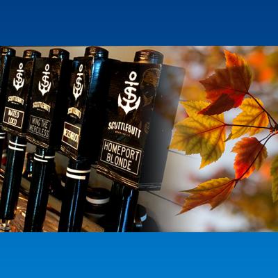 Row of Scuttlebutt beer tap handles and fall-colored leaves