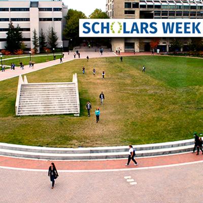 Students walk past the buildings, outdoor sculpture, and grassy plaza at the south end of Western's campus.