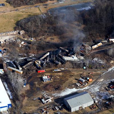 Smoke rises from the charred wreckage of derailed trains in East Palestine, Ohio