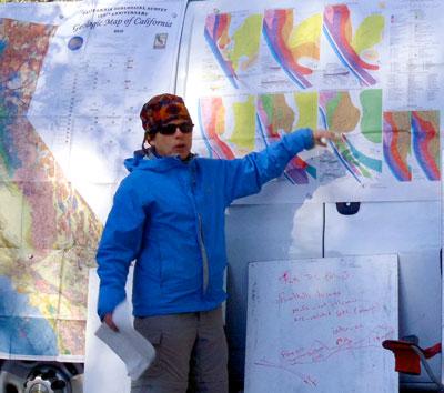Professor Liz Schermer pointing to large charts on a WWU Geology van