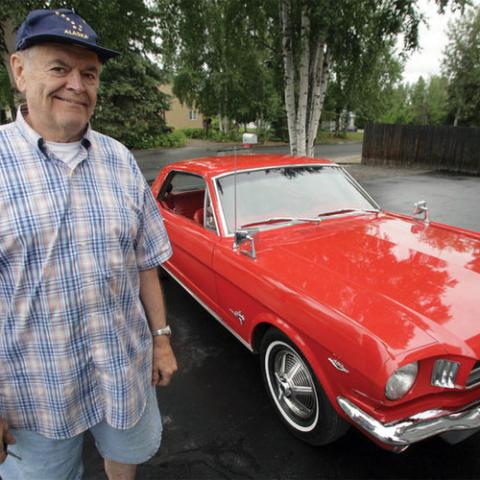 Dale Durrwachter standing next to an old car